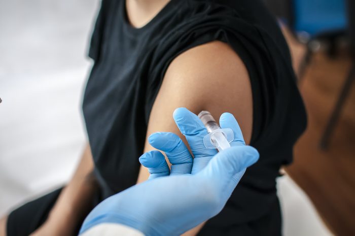 Doctor performs vaccination on young girl