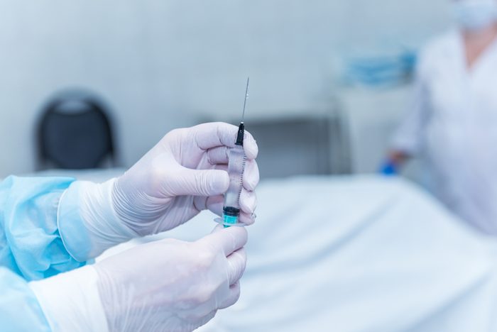The hands of an anesthetist, who are taking medicine from the ampoule in a syringe. concept photo anesthesia, medicine without pain