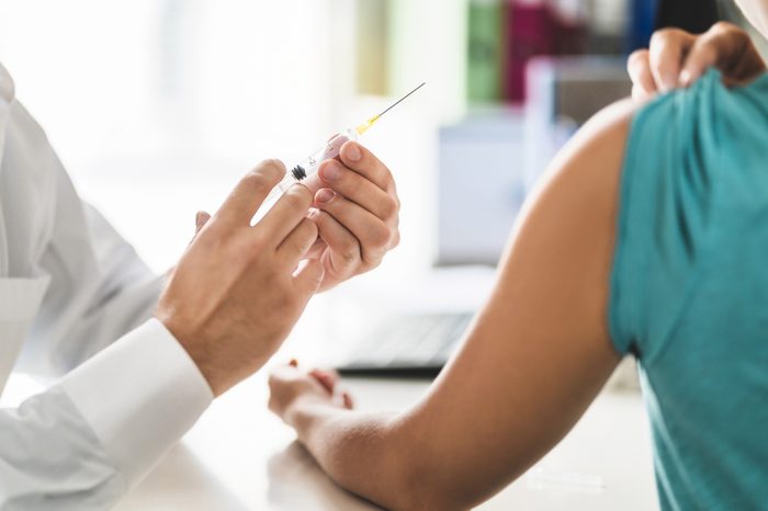 doctor with vaccine injection needle