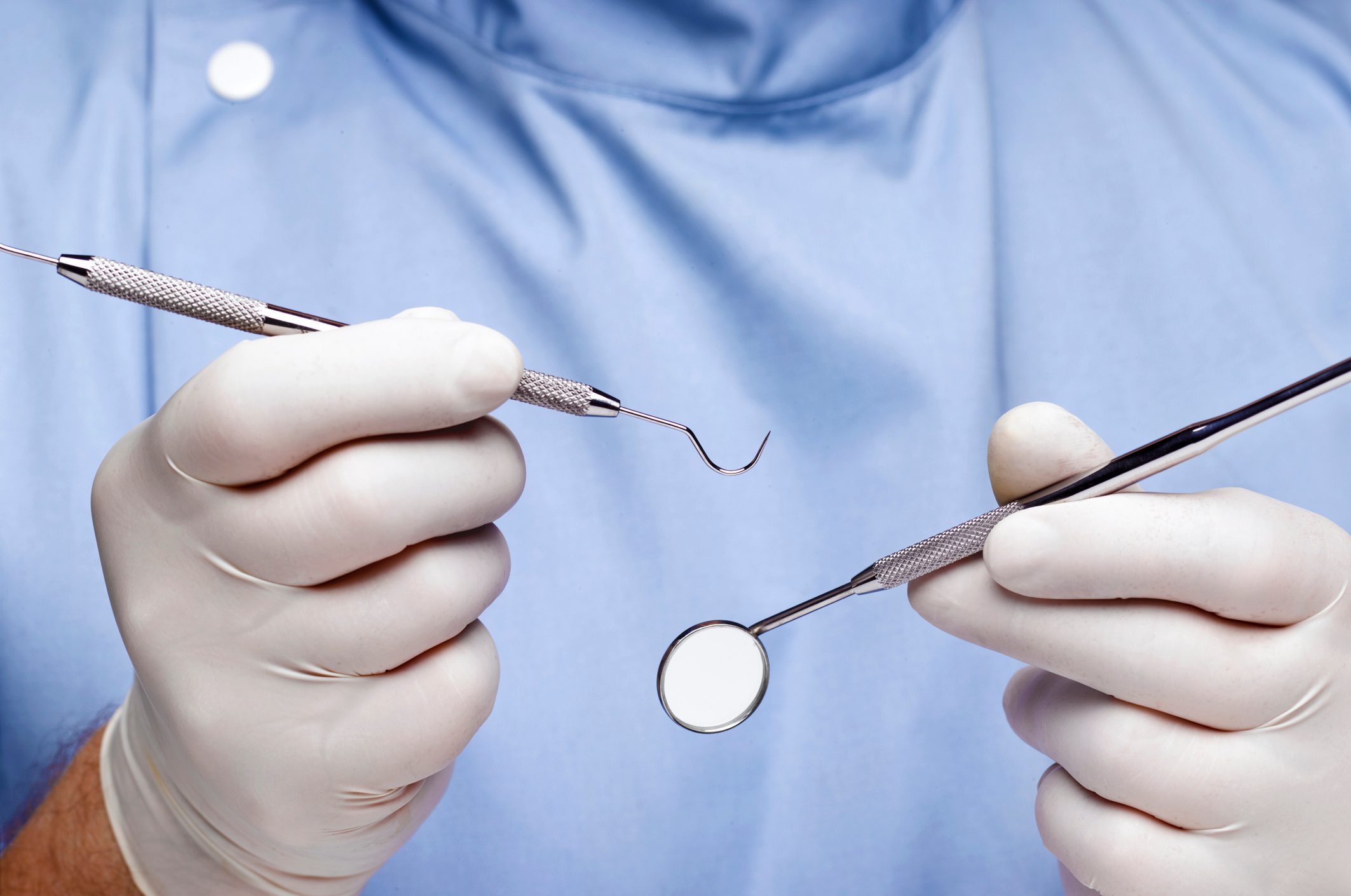 dentist holding dental tools