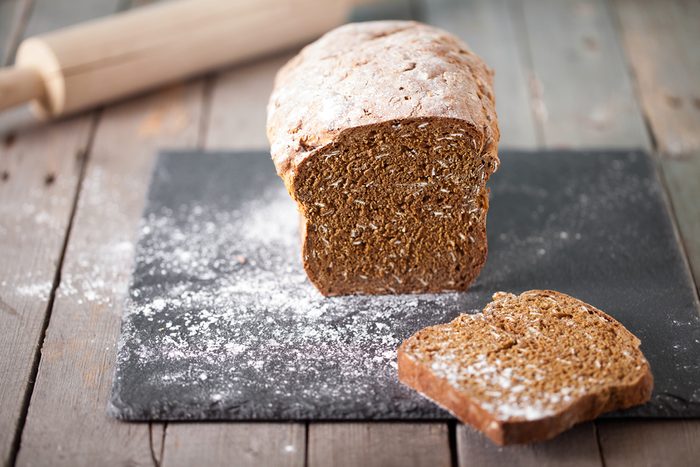 Fresh Irish soda bread with oat sliced on a slate cutting board Wooden background Copy space Selective focus