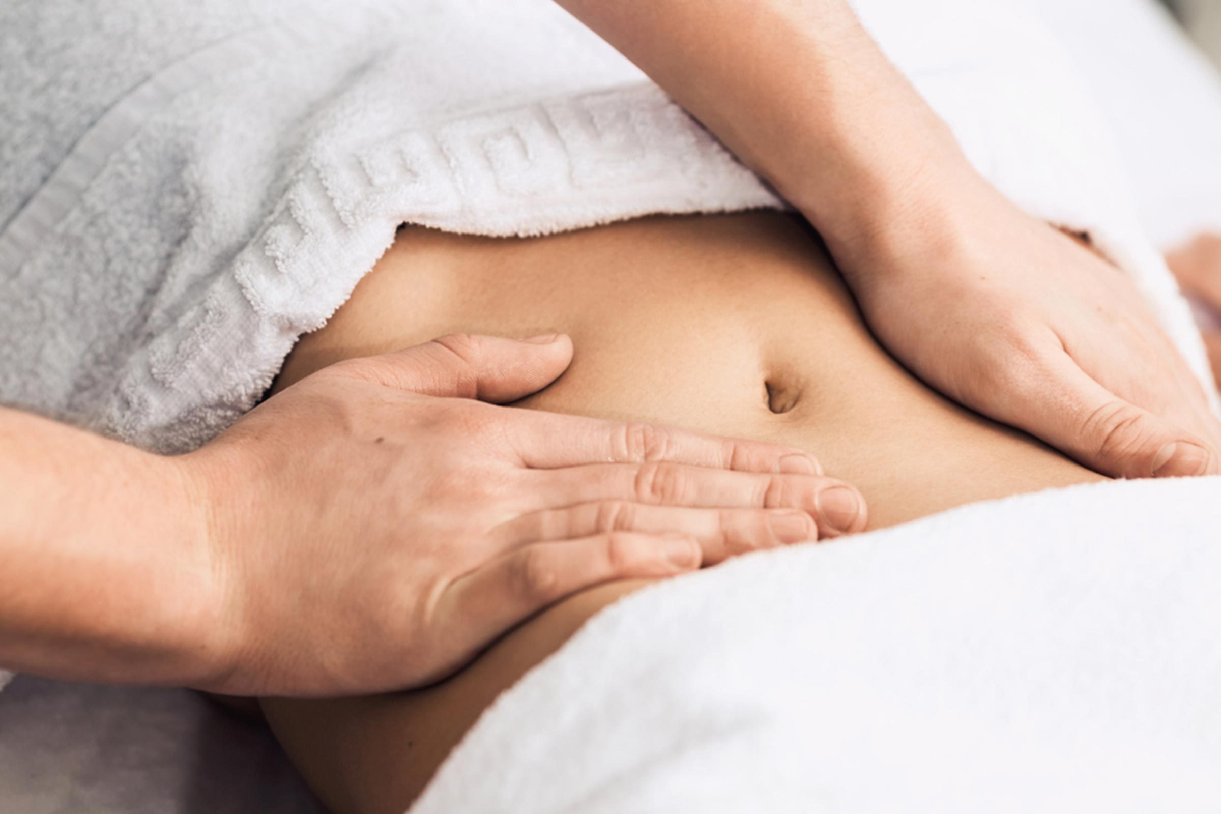 woman with hands on her abdomen