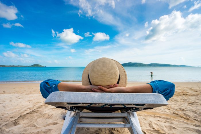 Young woman relaxing on beach, ocean view, Vacation Outdoors Seascape Concept