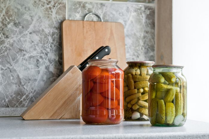 pickled cucumber and tomato in glass on the kitchen table