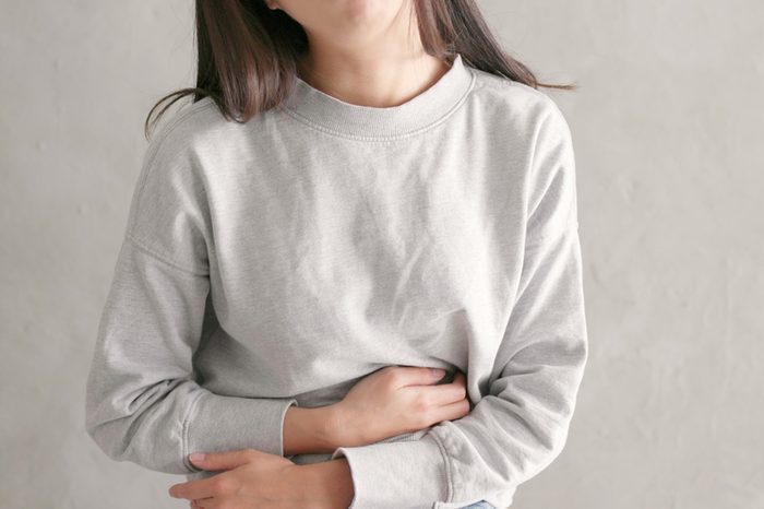  Woman holding her stomach in pain 