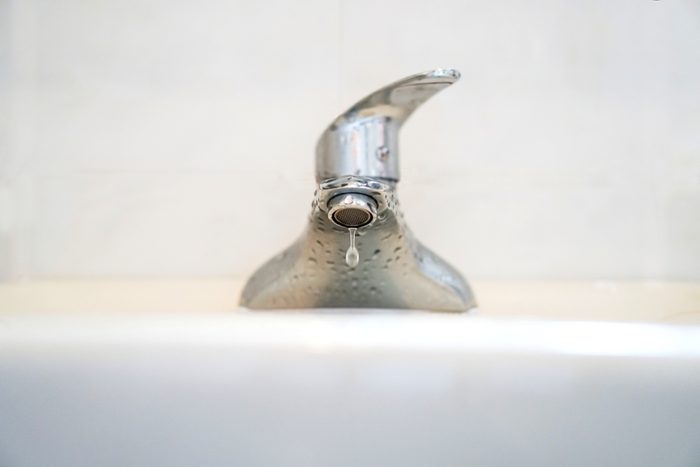 Faucet with water.Drop of water.
