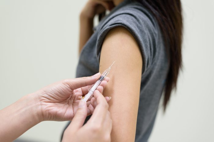 doctor injecting woman's arm with a needle