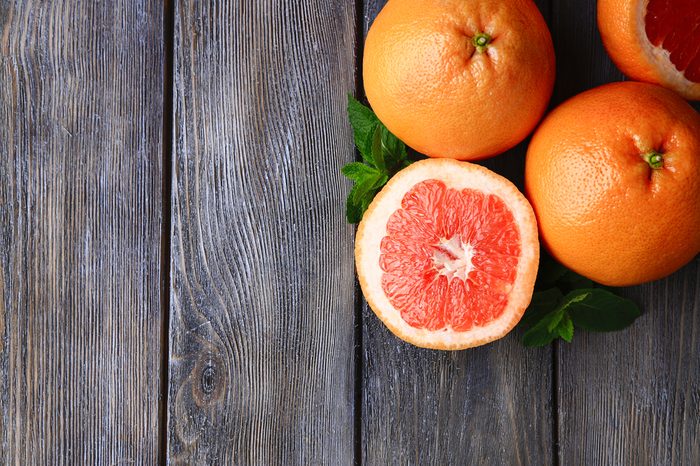 Ripe grapefruits on wooden background