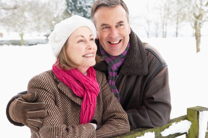 Senior Couple Standing Outside In Snowy Landscape