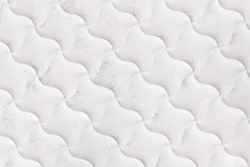 Background of soft comfortable quilted white mattress