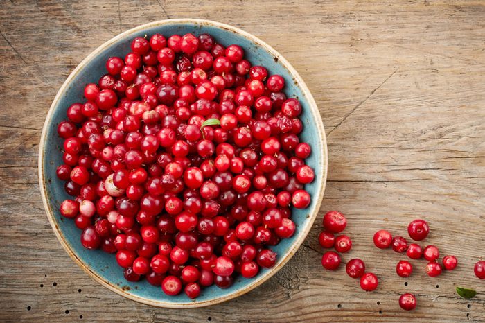 bowl of cowberries on old wooden table