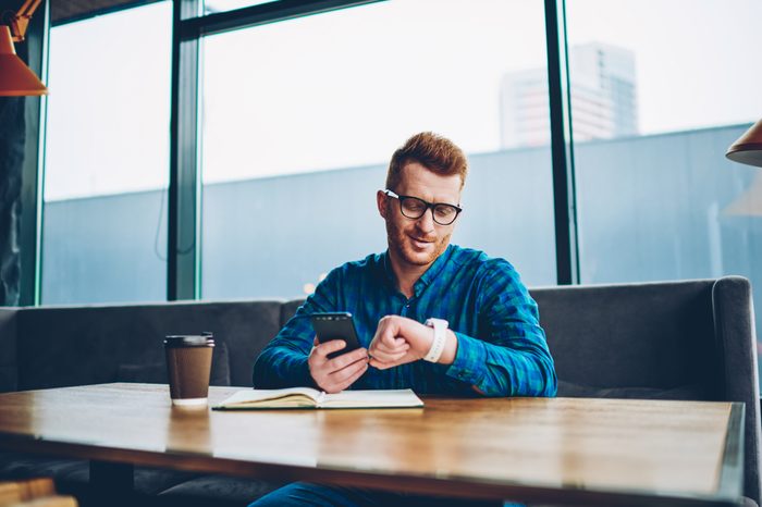 Young man looking at smartwatch 