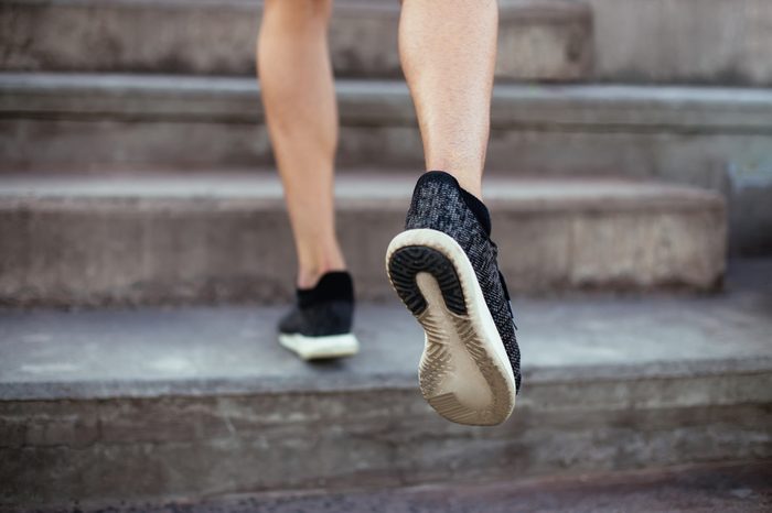 Back view of legs climbing stairs