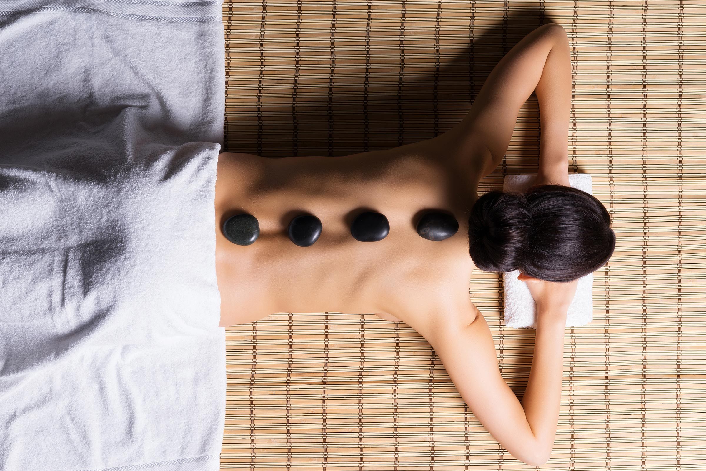 woman getting a hot stone massage