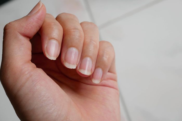 a woman's hand, with the palm and nails visible
