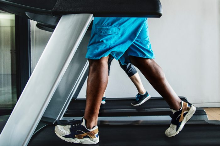 Man running on a treadmill at the gym.