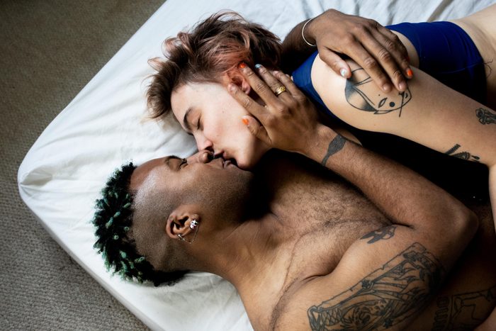 couple kissing in bed