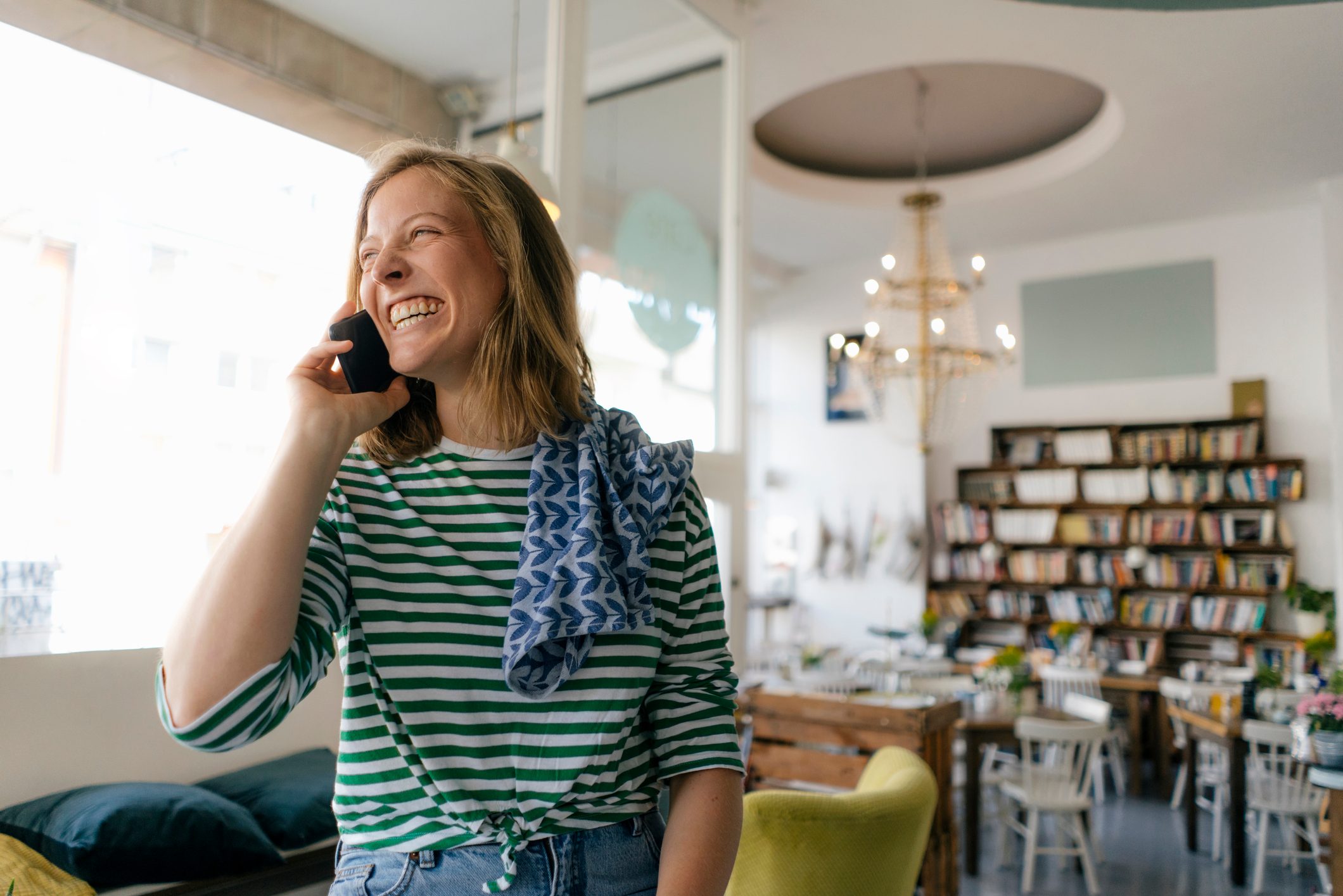 woman on smiling on the phone with a friend