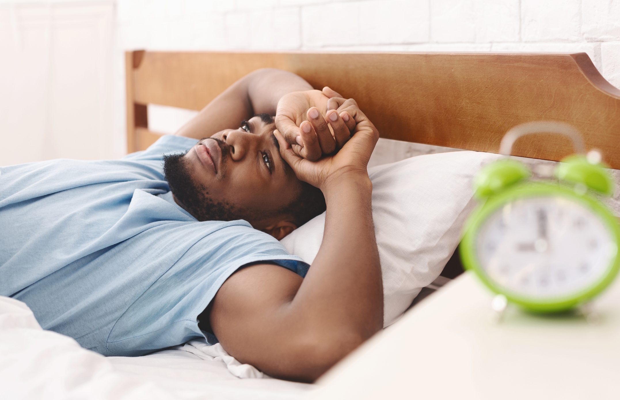 Man in bed thinking