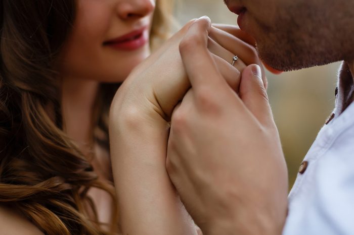 Man kissing woman's hand