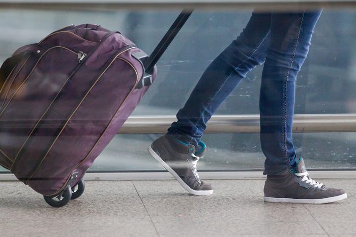 Woman carries your luggage at the airport terminal of Hong Kong