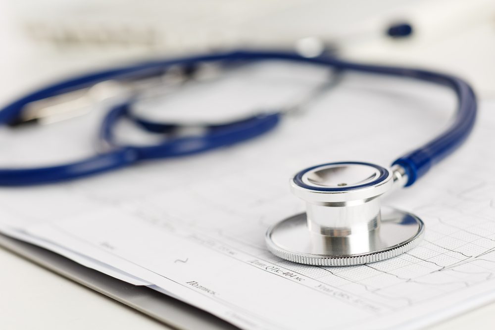 Medical stethoscope lying on cardiogram chart closeup. Medical help, prophylaxis, disease prevention or insurance concept. Cardiology care,health, protection and prevention. Healthy life concept