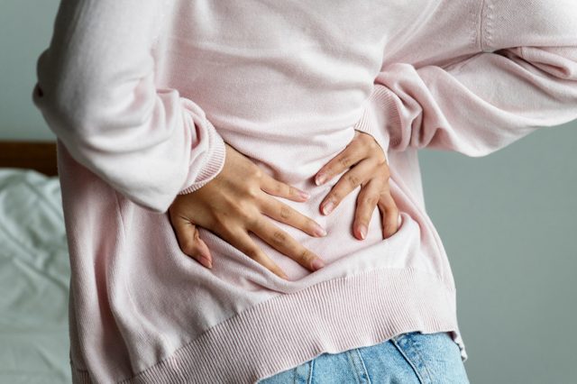 Asian woman suffering back pain