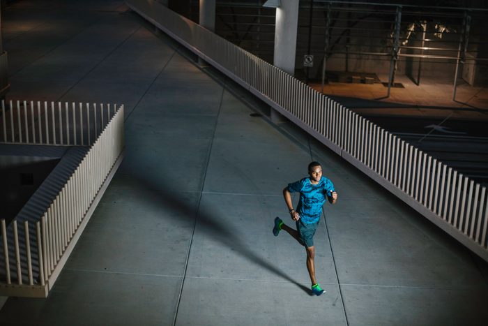 man running outside at night time