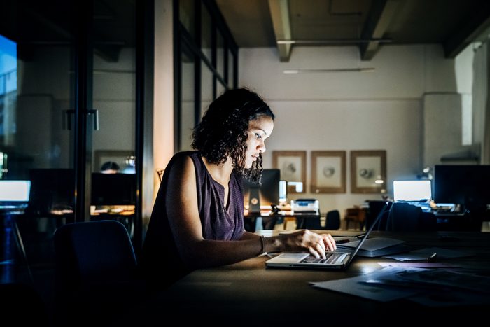 young woman working late