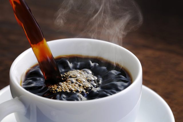 Aachen/ Germany - 07.12.2018: Coffee cup and coffee beans on wooden table