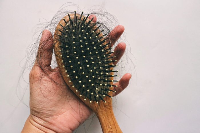Hair loss inside wood comb brush, on hand
