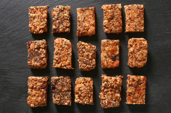 Tasty granola bars on dark background