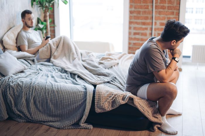 sad depressed men couple bed