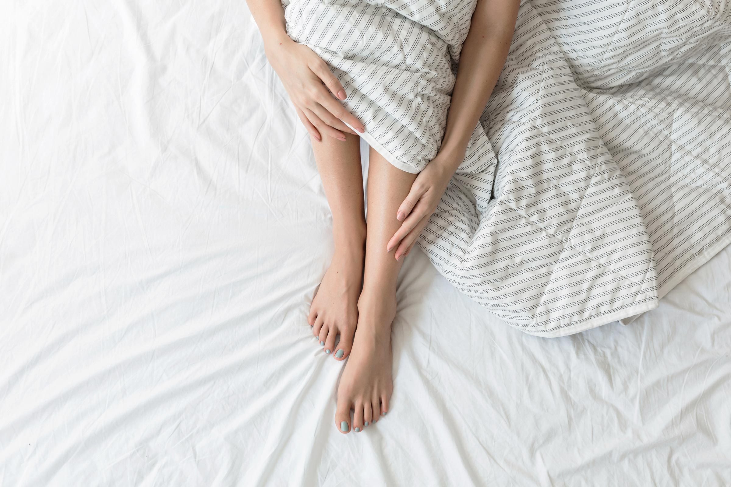 feet legs sheets bed