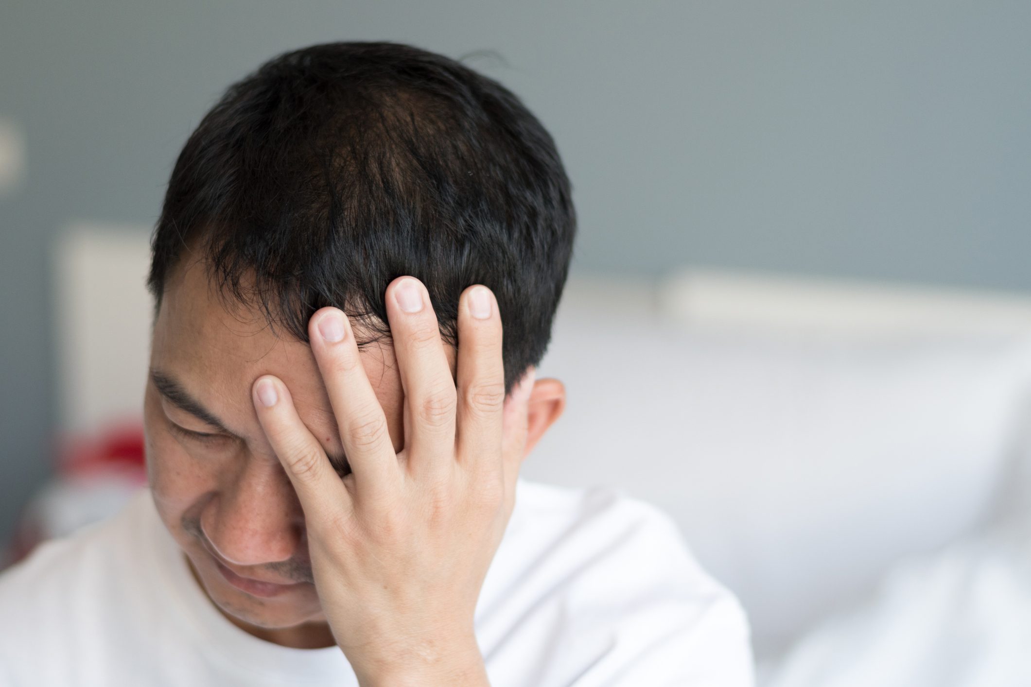 Man with hand on head
