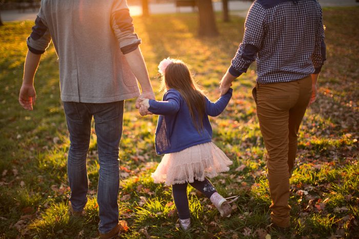 young parents taking their daughter for a morning walk