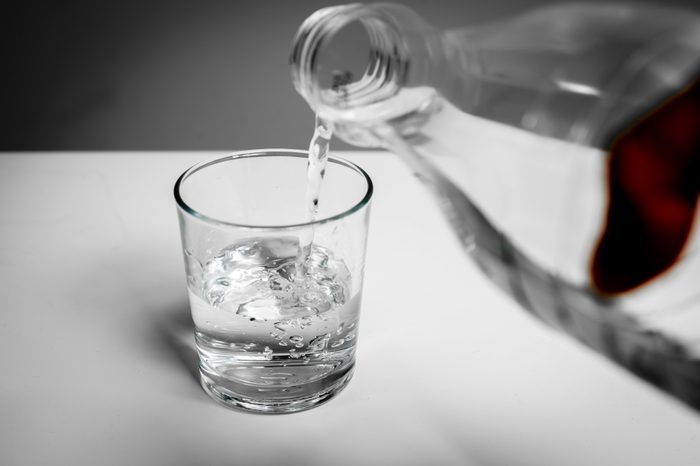 Pouring water into a glass from a bottle. The price is rising. Quenches thirst. Problems with water in some countries.The glass is filled with water.