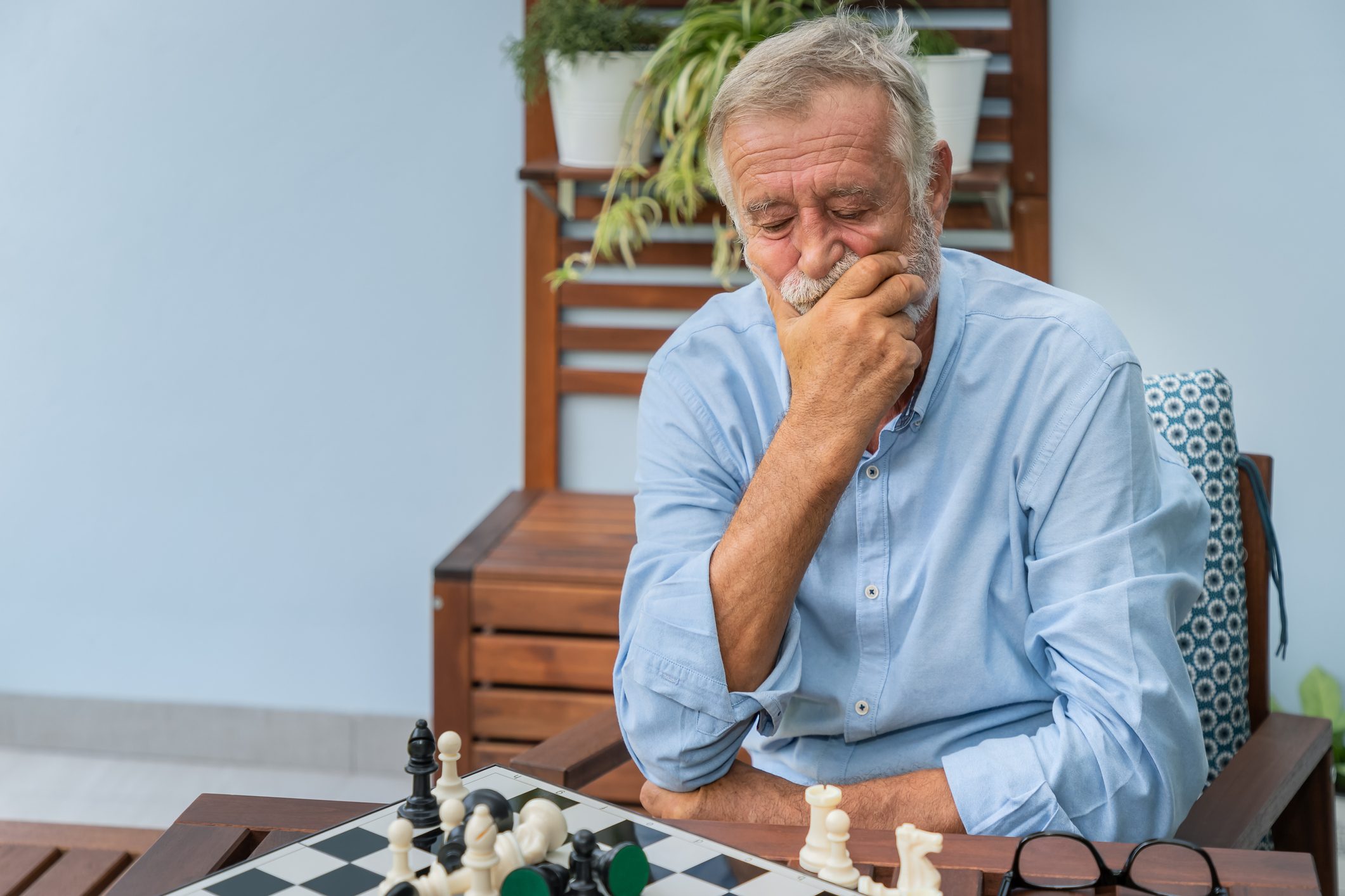 senior man playing chess