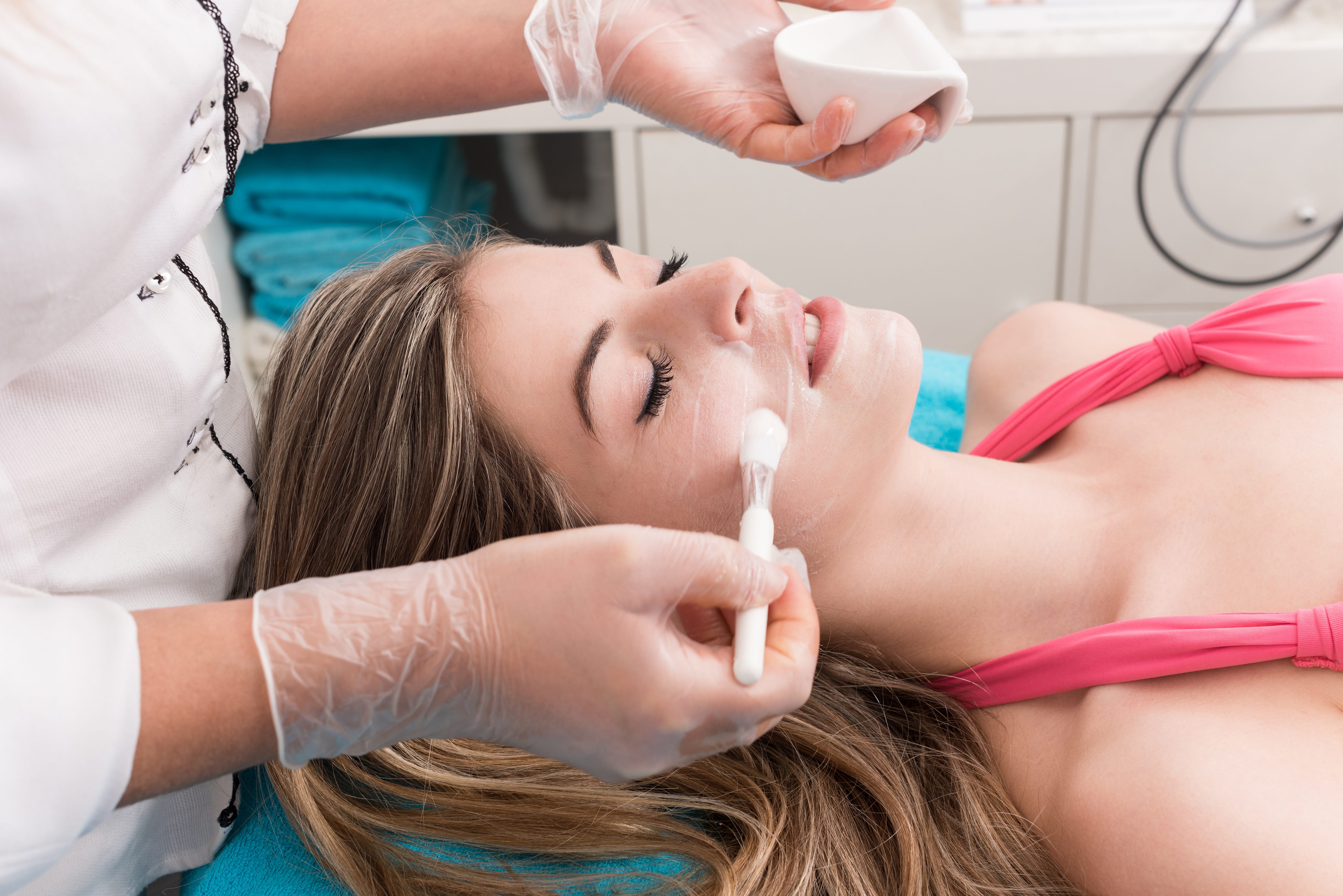 Woman having a facial massage and peeling in beauty salon