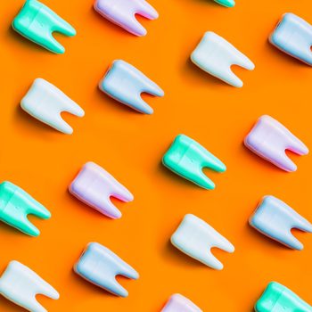 Teeth pattern on yellow bright background. Top view. Close up. Minimal dental care concept.