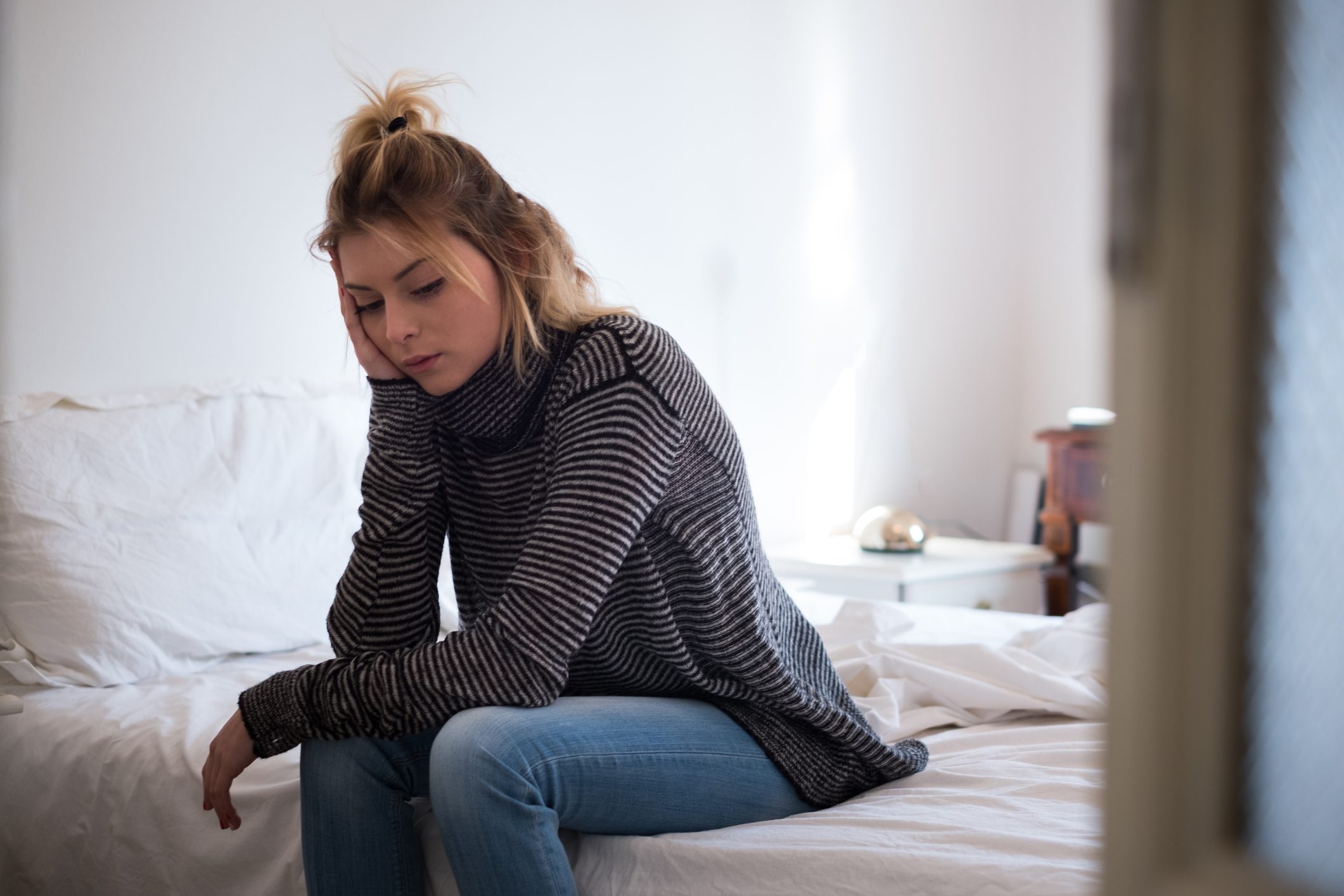 girl alone in bedroom upset