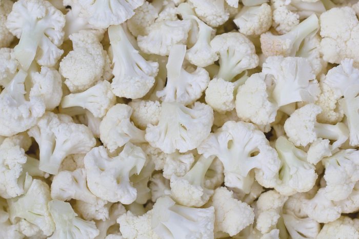 Small pieces of cauliflower in a real image. Heads, cauliflower inflorescence. Vintage of cauliflower. Fruits of cauliflower. 