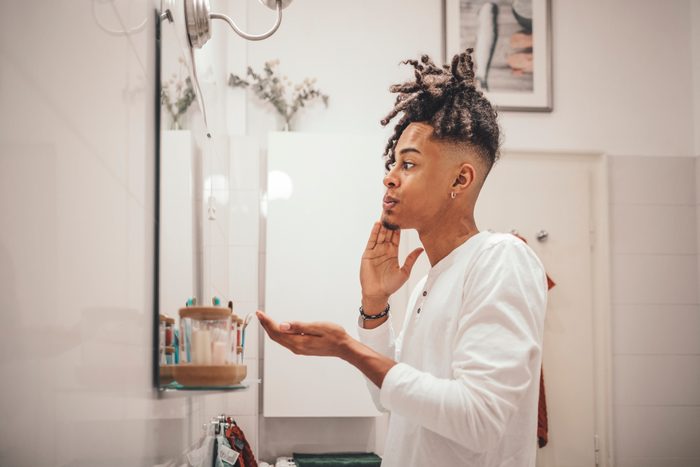 young man in bathroom skin care