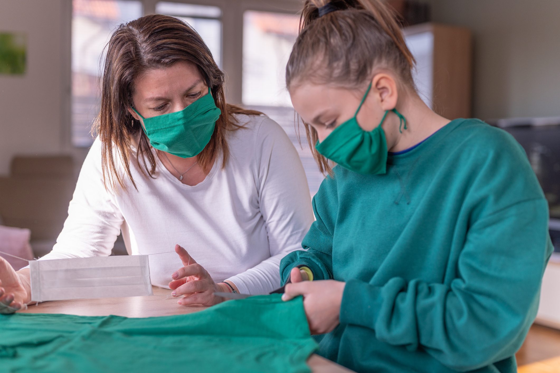 mother and daughter making face masks at home