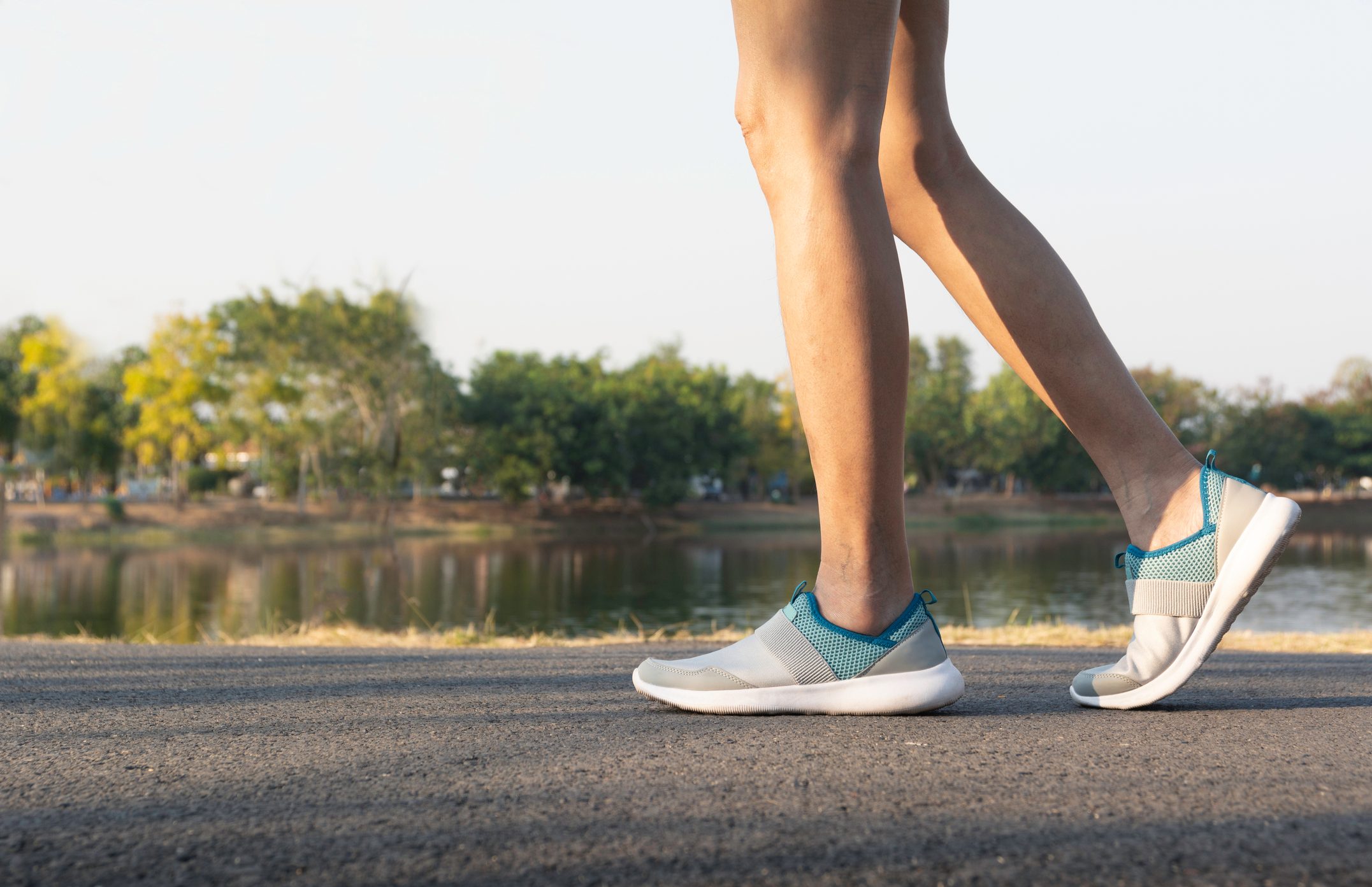cropped low section of woman walking outside
