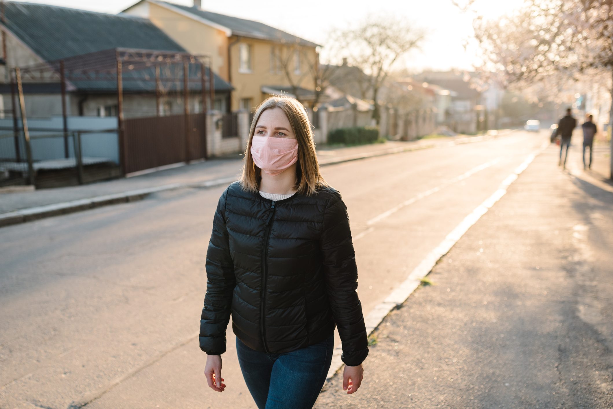 woman walking with mask on during coronavirus pandemic