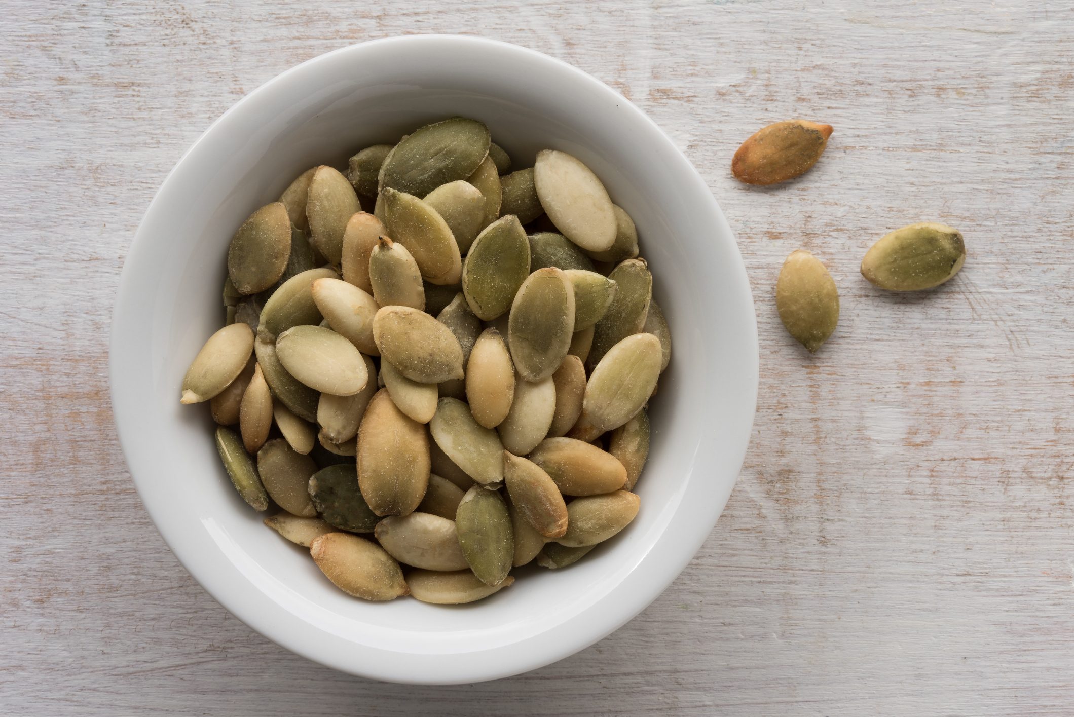 pumpkin seeds in bowl shot from above