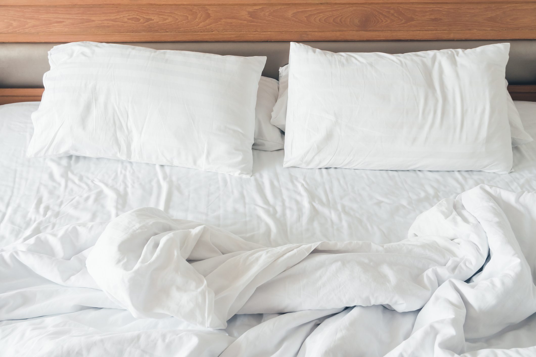 empty bed with pillows and comforter