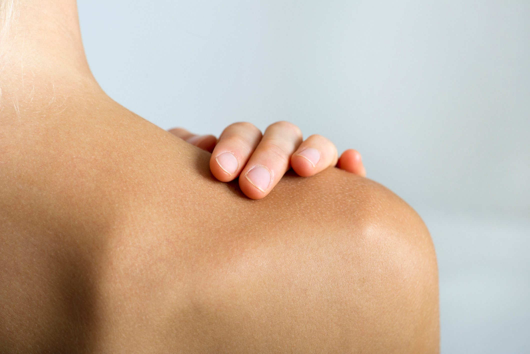 close up of woman's hand on shoulder