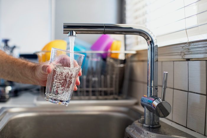 getting a glass of water from the sink
